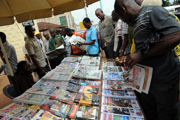 People read the newspapers' headlines following the Presidential election's results, announced by the Independent Electoral Commission, at a roadside in Asaba, Delta State, on April 19, 2011. AFP PHOTO / PIUS UTOMI EKPEI (Photo credit should read PIUS UTOMI EKPEI/AFP/Getty Images)